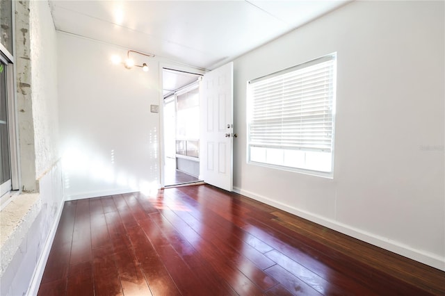 spare room with dark hardwood / wood-style floors