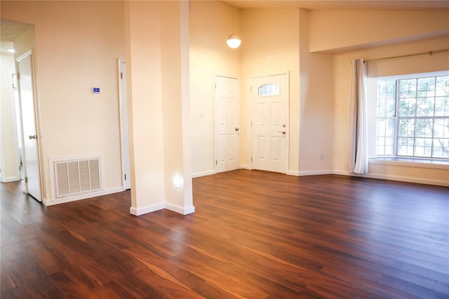 foyer with high vaulted ceiling and dark hardwood / wood-style floors