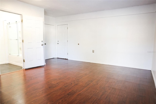 empty room with dark hardwood / wood-style floors