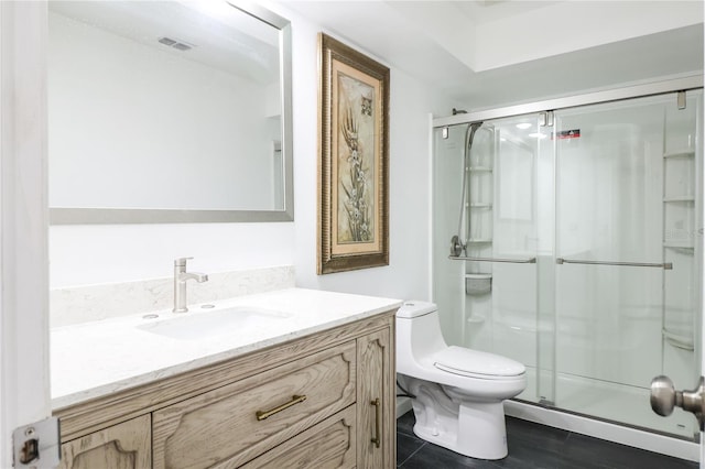 bathroom with an enclosed shower, vanity, toilet, and hardwood / wood-style floors