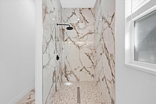 bathroom featuring marble finish floor and a marble finish shower