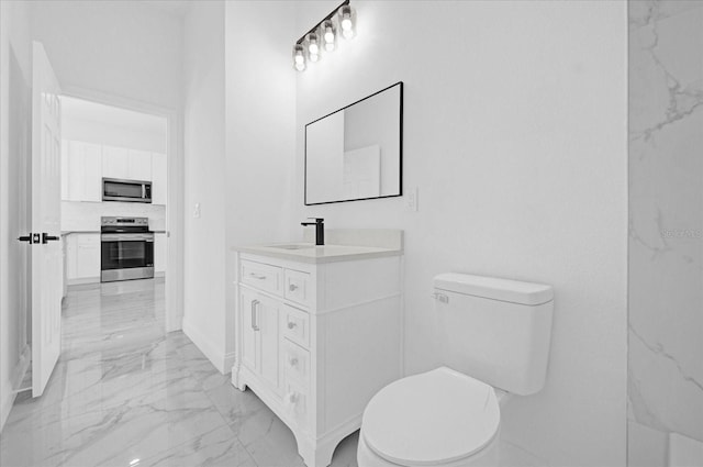 bathroom with marble finish floor, vanity, and toilet