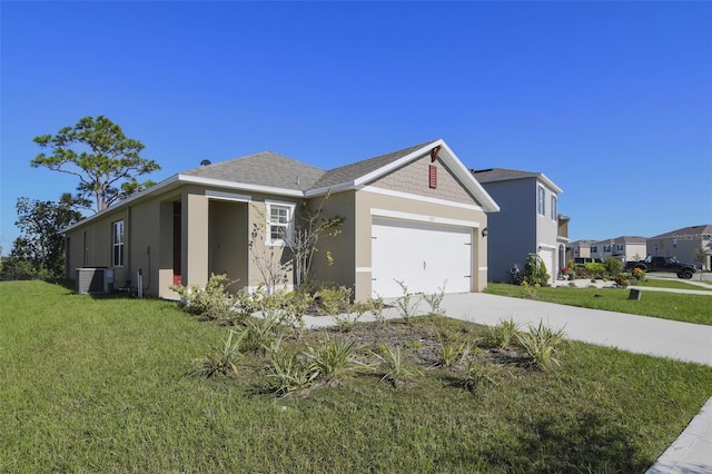 view of front of property featuring a front yard, a garage, and cooling unit