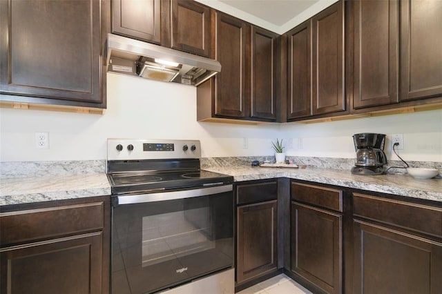 kitchen featuring dark brown cabinetry, extractor fan, and electric stove