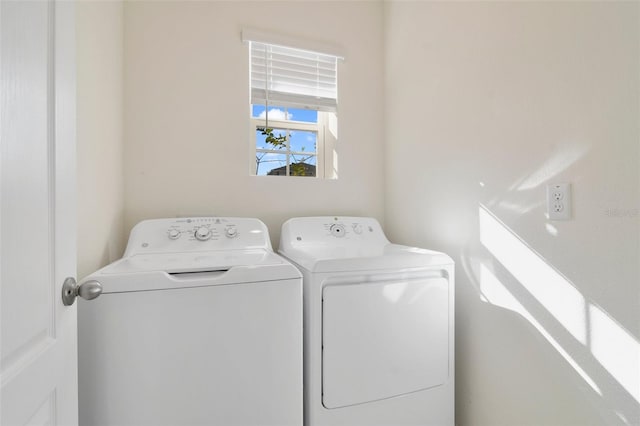 clothes washing area with washing machine and clothes dryer