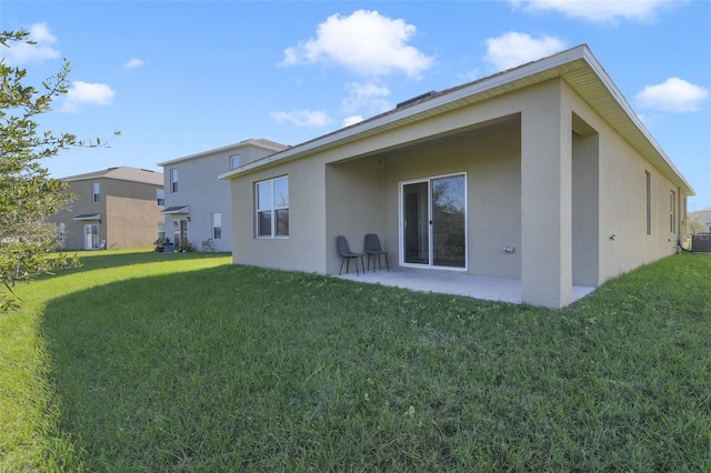 rear view of house featuring a lawn, a patio area, and central AC