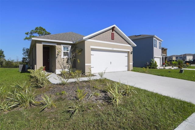 view of front facade featuring central AC, a garage, and a front lawn