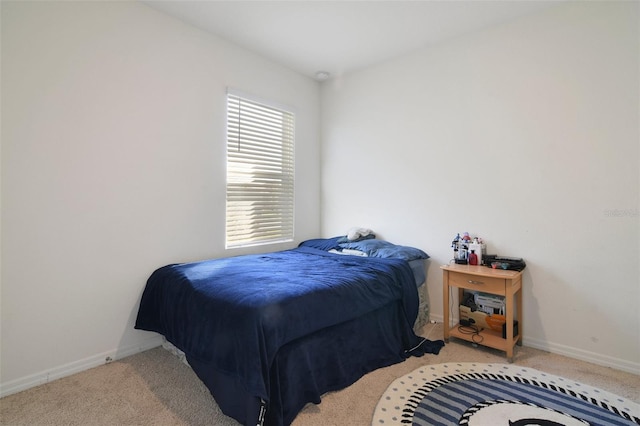 bedroom featuring light colored carpet