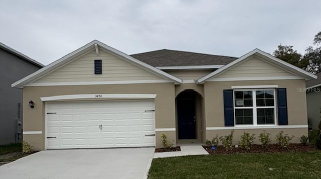 ranch-style home featuring stucco siding, a shingled roof, a front yard, a garage, and driveway