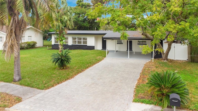 ranch-style home with a front yard and a carport