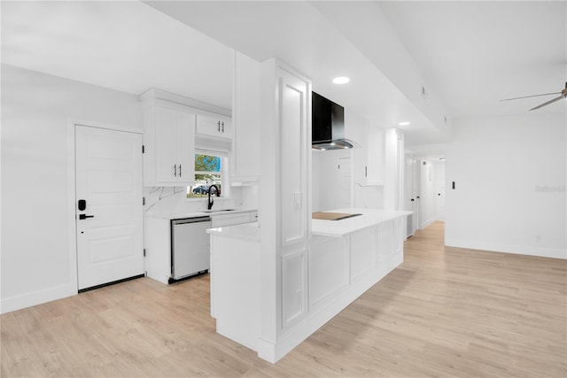 kitchen featuring white dishwasher, wall chimney exhaust hood, backsplash, white cabinetry, and light wood-type flooring