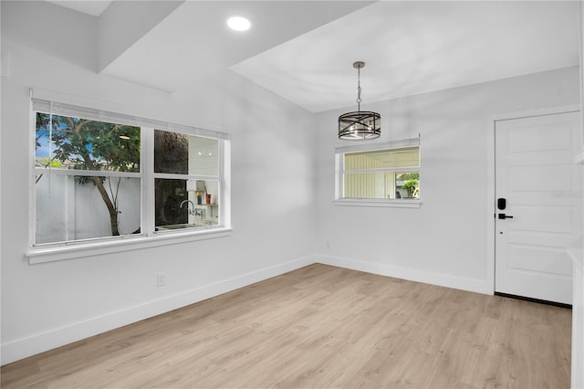 entryway featuring an inviting chandelier and light hardwood / wood-style flooring