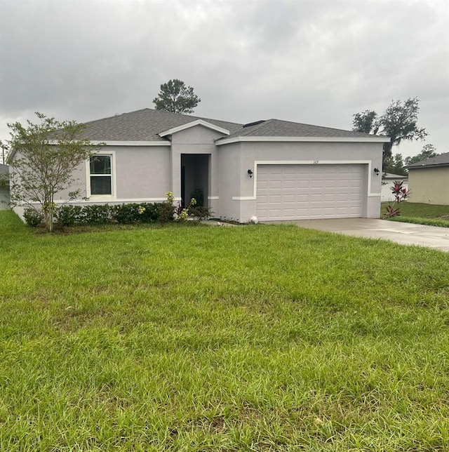 ranch-style house with a garage and a front yard