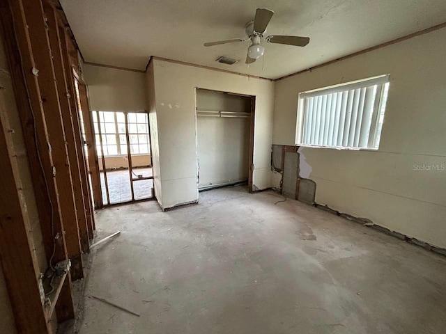 unfurnished bedroom with multiple windows and ceiling fan