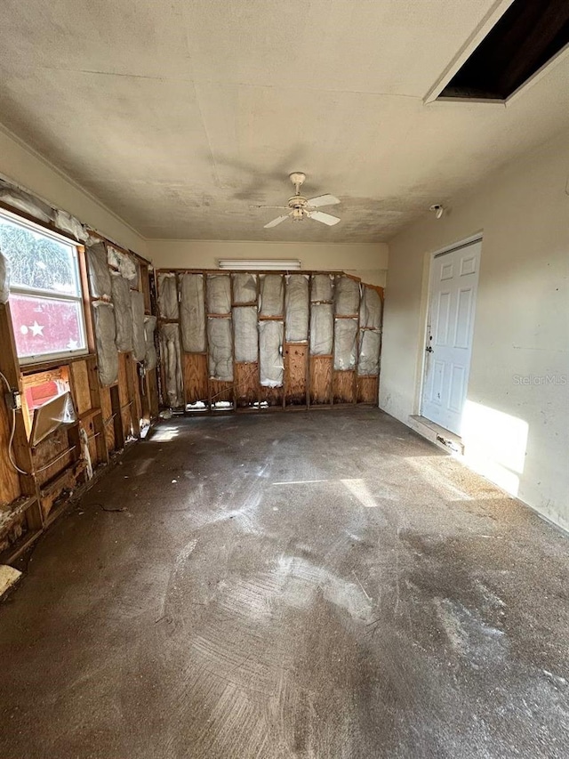 misc room featuring dark carpet and ceiling fan