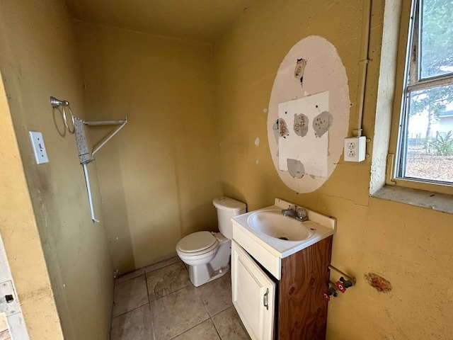 bathroom featuring toilet, vanity, and tile patterned flooring