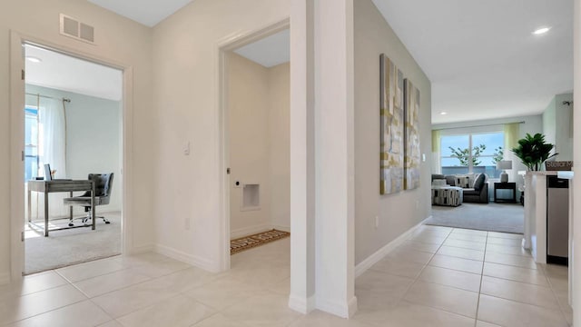 hallway with light colored carpet