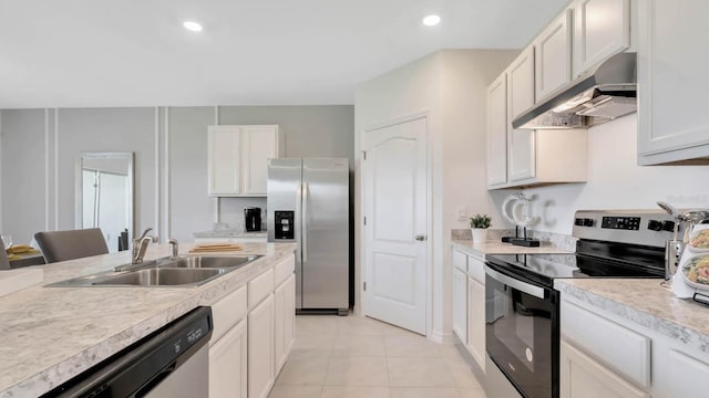 kitchen featuring white cabinetry, stainless steel appliances, sink, and light tile patterned flooring