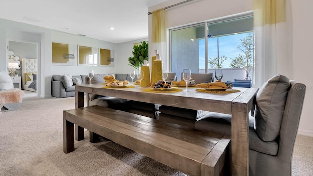 dining area with light colored carpet