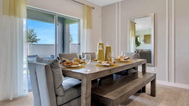 dining area featuring light carpet