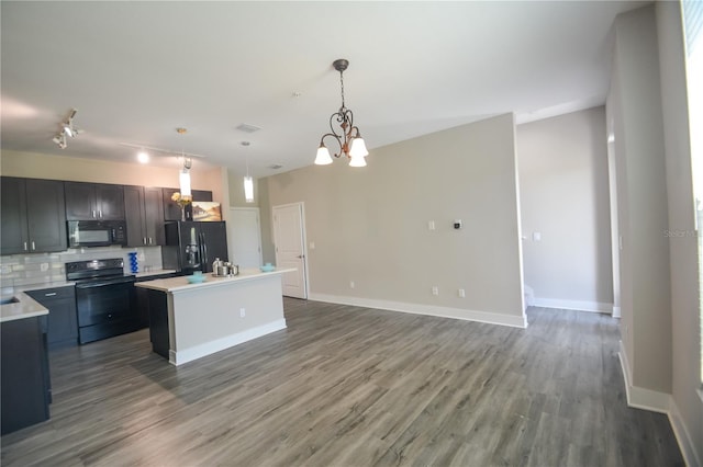 kitchen with a center island, hanging light fixtures, black appliances, tasteful backsplash, and dark hardwood / wood-style floors