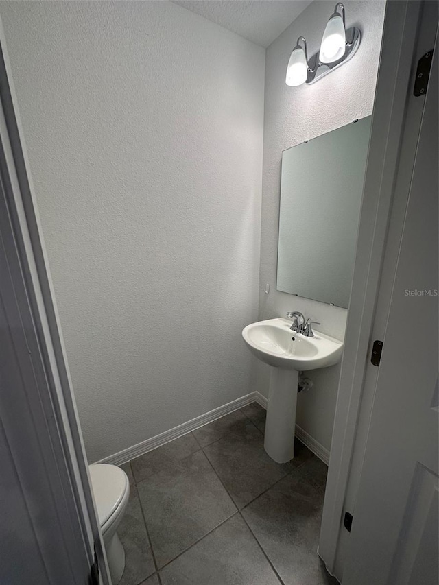 bathroom featuring tile patterned floors and toilet