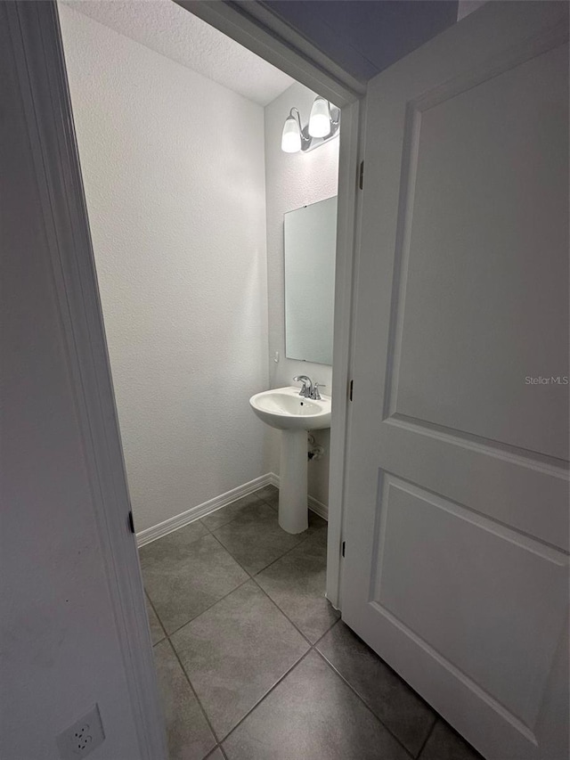 bathroom with tile patterned floors and sink