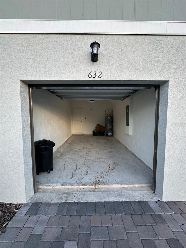 garage with electric panel and water heater