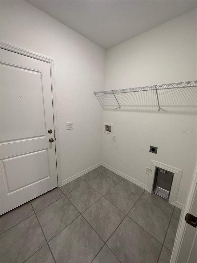 laundry room featuring electric dryer hookup, light tile patterned floors, and hookup for a washing machine