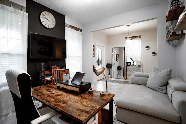 living room featuring plenty of natural light and a textured ceiling