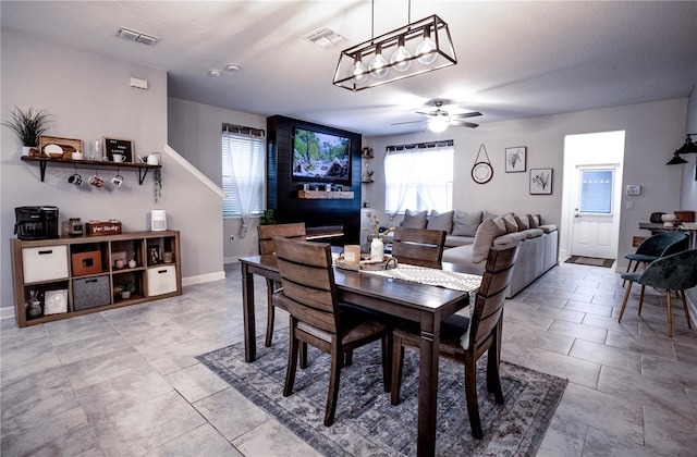 dining area featuring ceiling fan, plenty of natural light, light tile patterned floors, and a textured ceiling