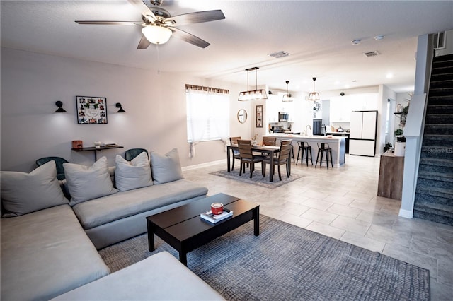 living room featuring ceiling fan and sink