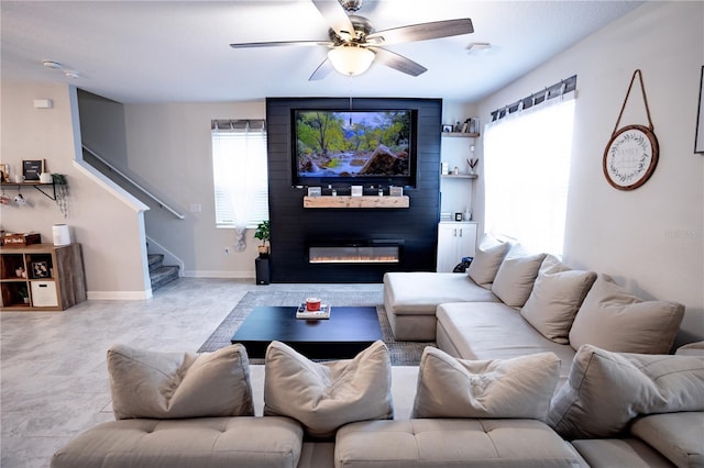 living room with a fireplace, ceiling fan, and light tile patterned flooring