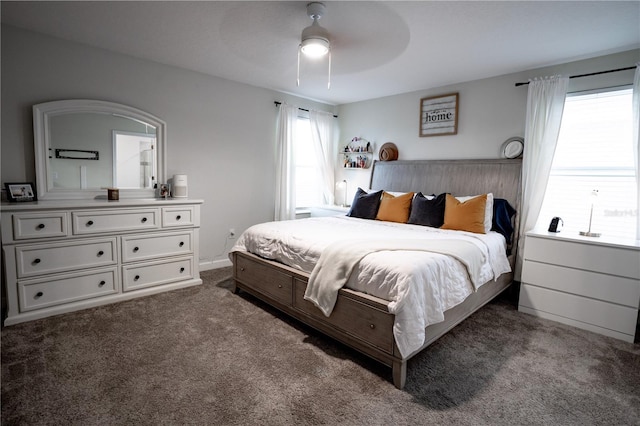 bedroom featuring ceiling fan and dark carpet