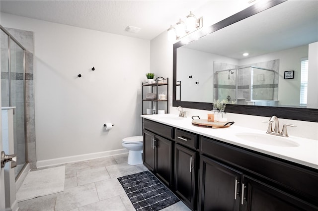 bathroom with toilet, tile patterned floors, a shower with door, a textured ceiling, and vanity