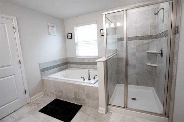 bathroom with tile patterned flooring and separate shower and tub