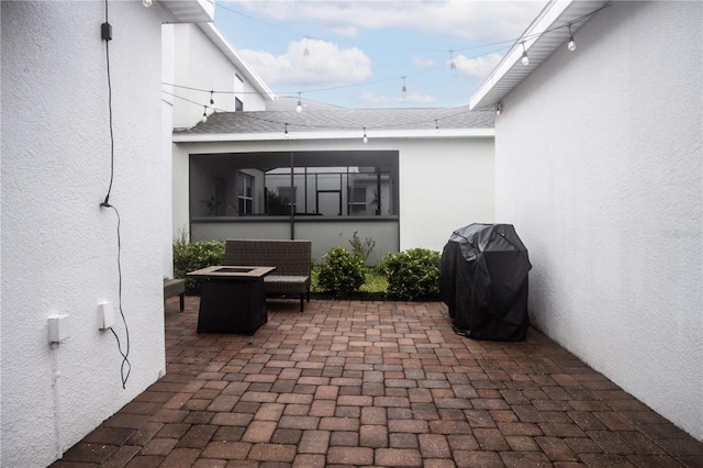 view of patio featuring an outdoor fire pit and a grill