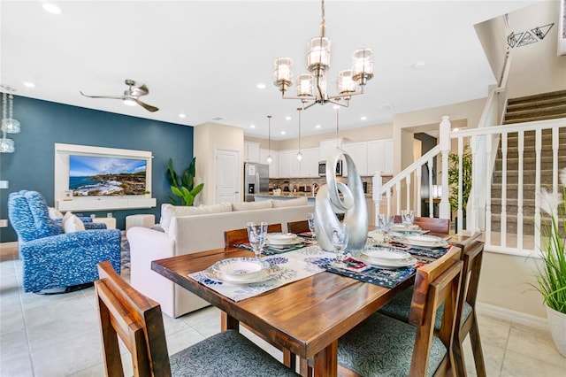 dining area with light tile patterned flooring and ceiling fan with notable chandelier