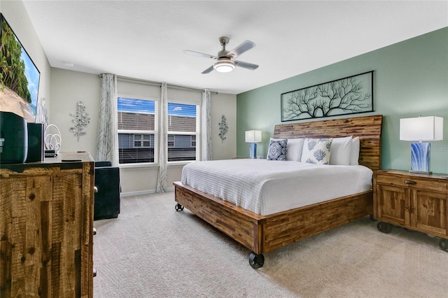 carpeted bedroom featuring multiple windows and ceiling fan