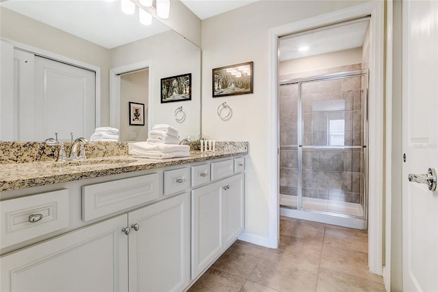 bathroom with vanity, tile patterned flooring, and a shower with shower door