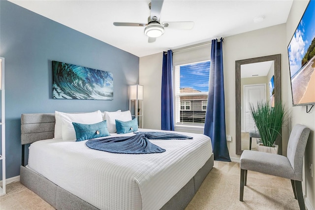 bedroom with light carpet and ceiling fan