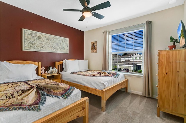 bedroom featuring light carpet and ceiling fan