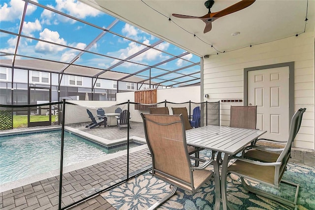 view of swimming pool with a lanai, ceiling fan, and a patio