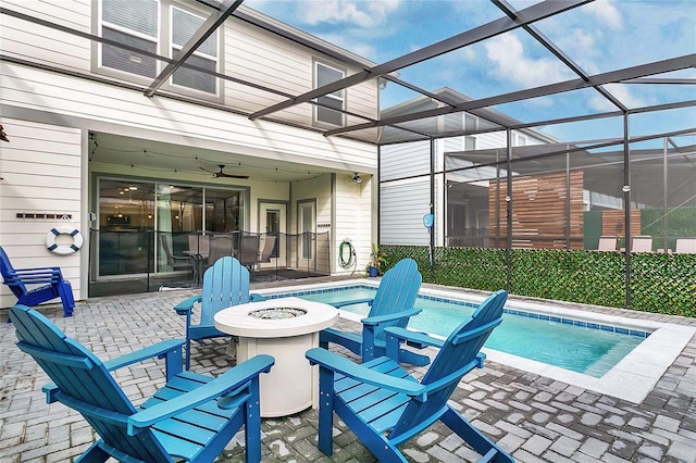 view of pool featuring ceiling fan, a lanai, and a patio