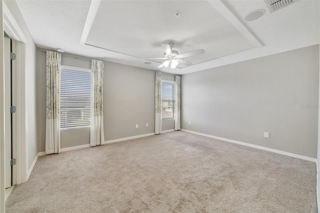 carpeted spare room with ceiling fan and a textured ceiling