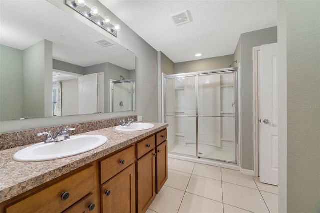 bathroom featuring an enclosed shower, vanity, and tile patterned floors