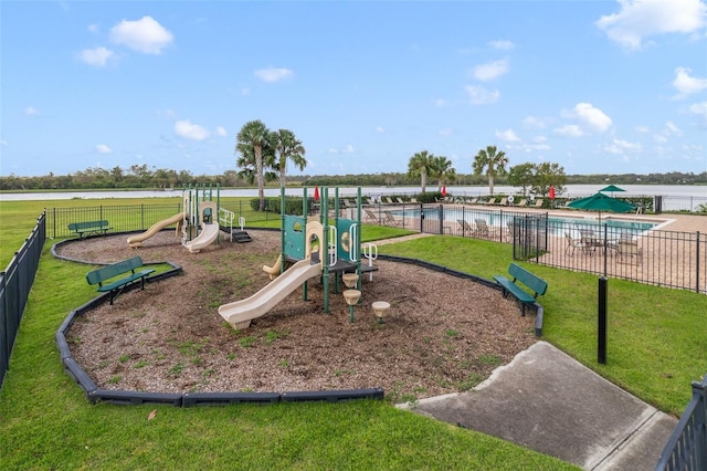 view of jungle gym with a yard and a water view