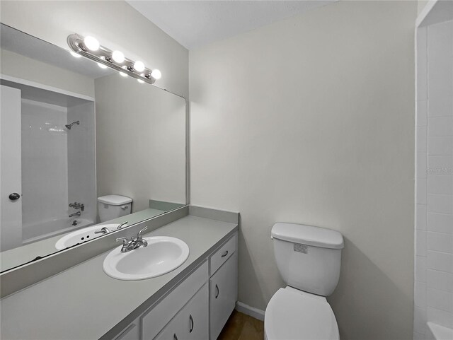 full bathroom featuring vanity, tub / shower combination, and toilet