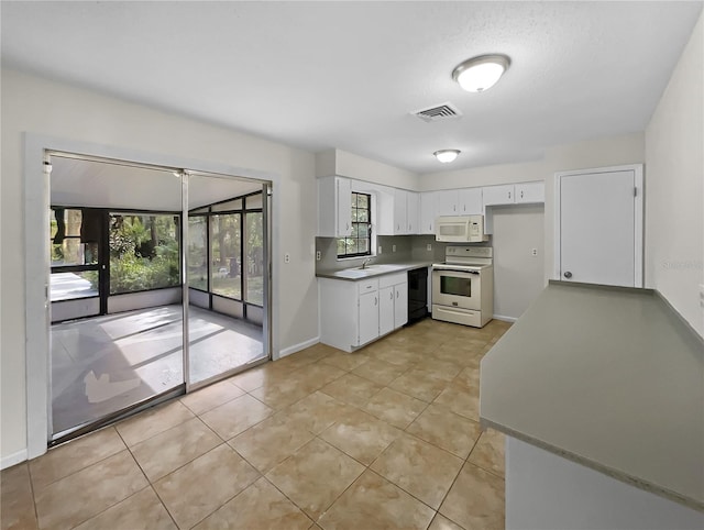 kitchen featuring white cabinetry, light tile patterned floors, and white appliances