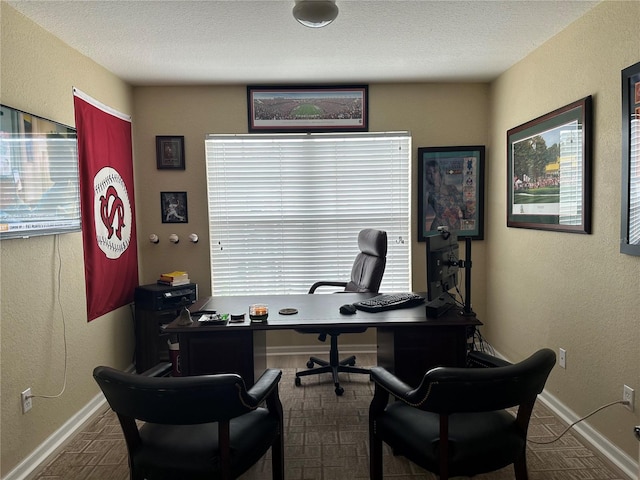 office area with a textured ceiling